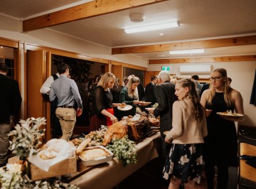 Guests enjoying the wide range of food on the sideboard 