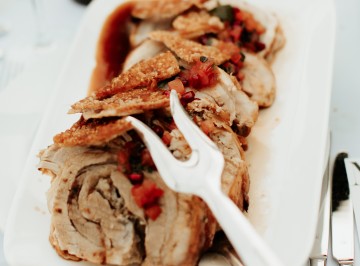 Rolled Canterbury porchetta with sourdough stuffing, crispy crackling and tomato, pomegranate and mint salsa.